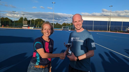Kate James presenting trophy to Albert Goodman